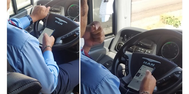Otobüs şoförünün bir elinde telefon, bir elinde çekirdek