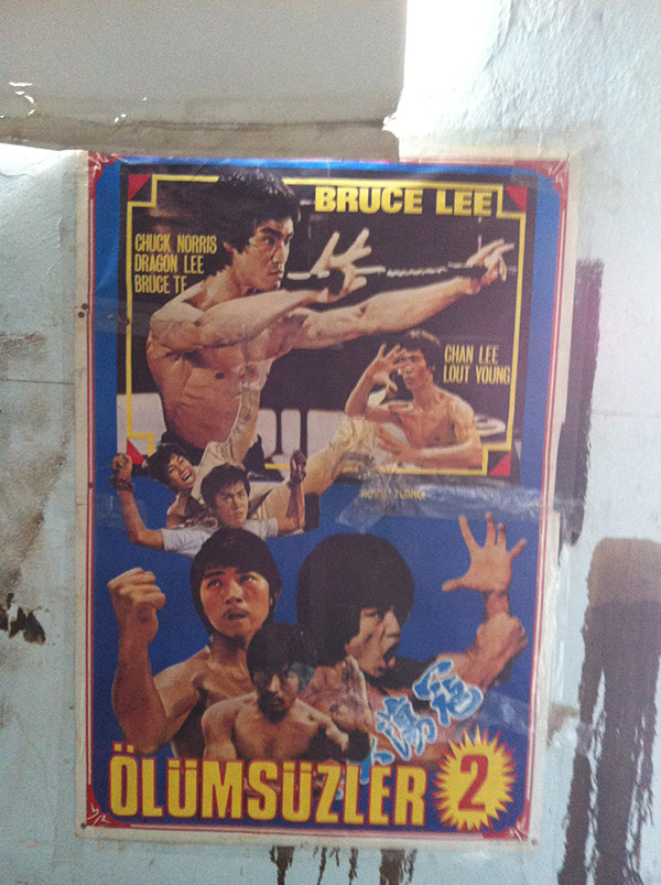 Salonun duvarlarında o döneme ait "Bruce Lee, Belmando, Maceracılar" afişleri dikkat çekici...