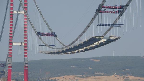 33'n tabliye blou yerletirildi<br>  Her biri 45 metre geniliinde, 48 metre uzunluunda ve 700 ton arlndaki tabliye bloklarnn balanaca ask halatlarnn ana halatlara montaj ilemi 6 Temmuz Sal gn balamt. Bugn de Asya ve Avrupa?daki kule ayaklarnn orta aklna 33?nc tabliye blou yerletirildi. Gemiyle getirilen tabliyelerin montaj itme- srme yntemi ile gerekletiriliyor.