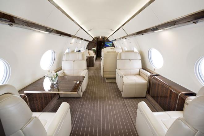 The 30-meter-long jet also features a customizable interior. The aircraft's main cabin, which has four living areas, consists of 10 seats and a sofa.  The cabin interior is designed with contrasting pale leather seats and wood furnishings, while the G650ER features 16 oval windows that Gulfstream says are the largest in aviation.