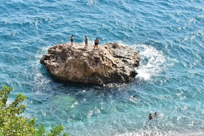 Konyaalt sahilinde bir grup gen, tehlikeli olmasna ramen kayalklardan denize atlayarak elendi