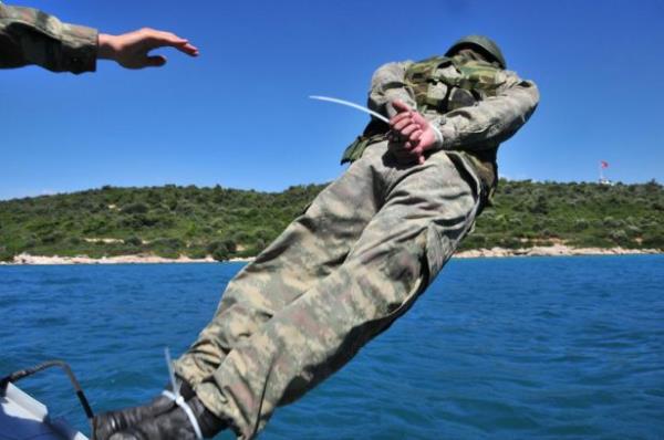 Eitimin bir dier blmnde ise botta el, ayak ve gzleri komutanlar tarafndan balanan komando adaylar, ardndan denize atlyor. El ve ayaklarn kullanmadan yzebilen kursiyerler, en yakn unsura ulaarak eitimi tamamlamaya alyor.