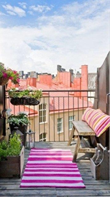 16- Terasa alan kapnn ardnda sade ama ho bir dekorasyon gryoruz. Herkesin kolaylkla uygulayabilecei bir neri olarak basit bir bank, pembe izgili dikdrtgen krlentler ve hal ile ahap detaylar ortama ayr bir scaklk katyor.